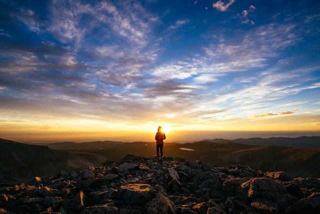 Happy open enrollment applicant observes a Colorado vista.