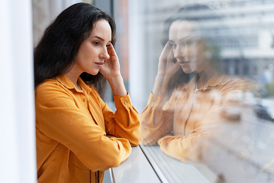 contemplative woman looking out of a window
