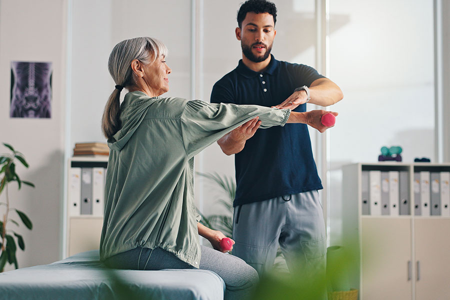 senior woman with her physical therapist
